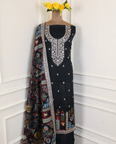 Black embroidered dress with a colorful dupatta on a white background